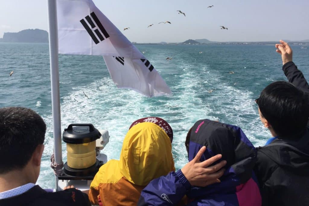 Feeding seagulls on ferry to Udo Island